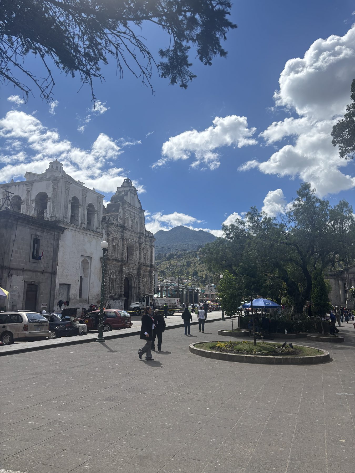 Xela's central plaza — a colonial cathedral, jacaranda trees, and the volcanoes of the Western Highlands beyond