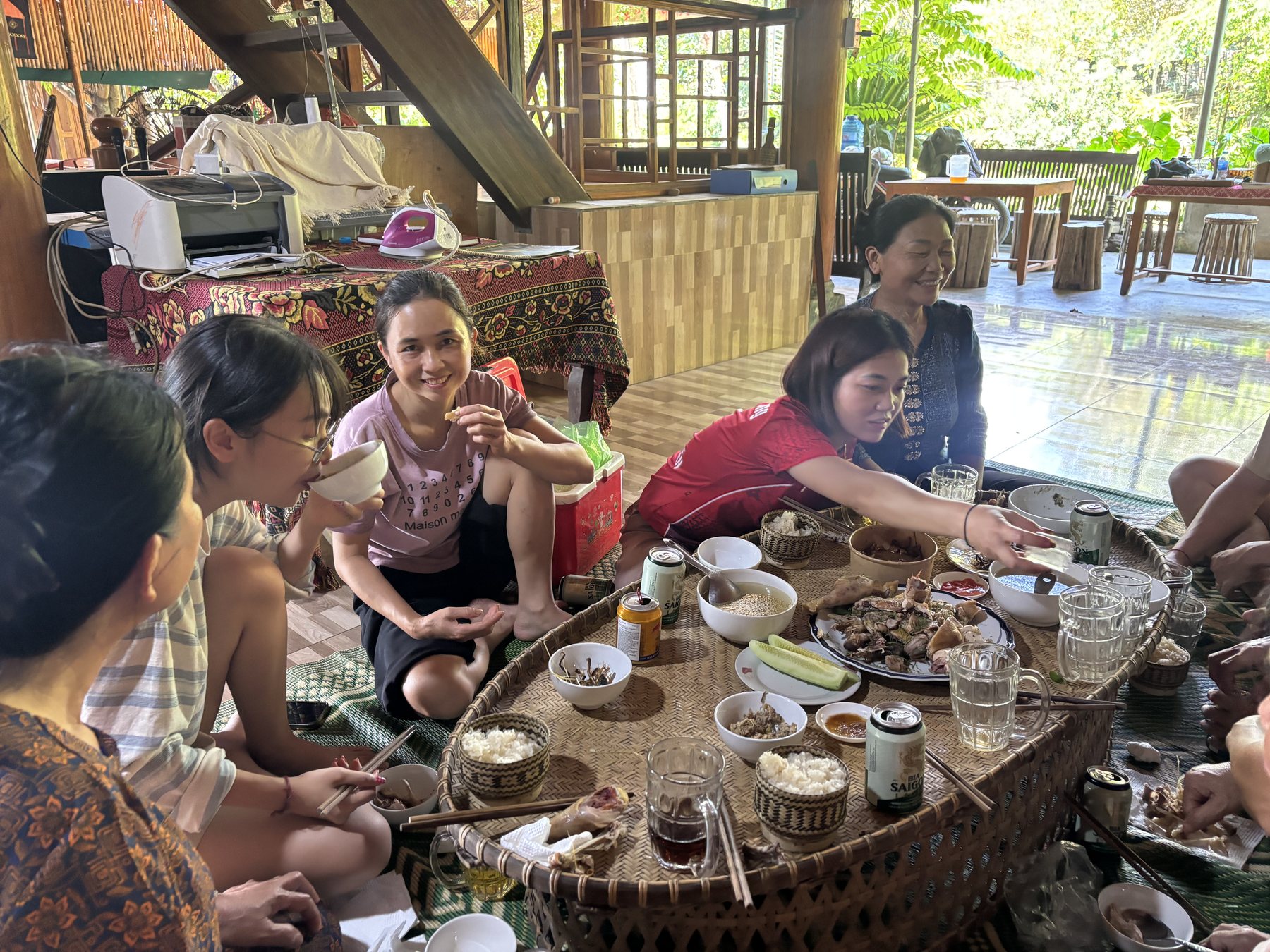 The women of Hoa Tiến sharing a meal around a low table